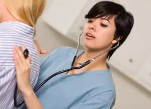 Vocational Nurse (VN) Diploma Program Student Listening to patient with stethoscope