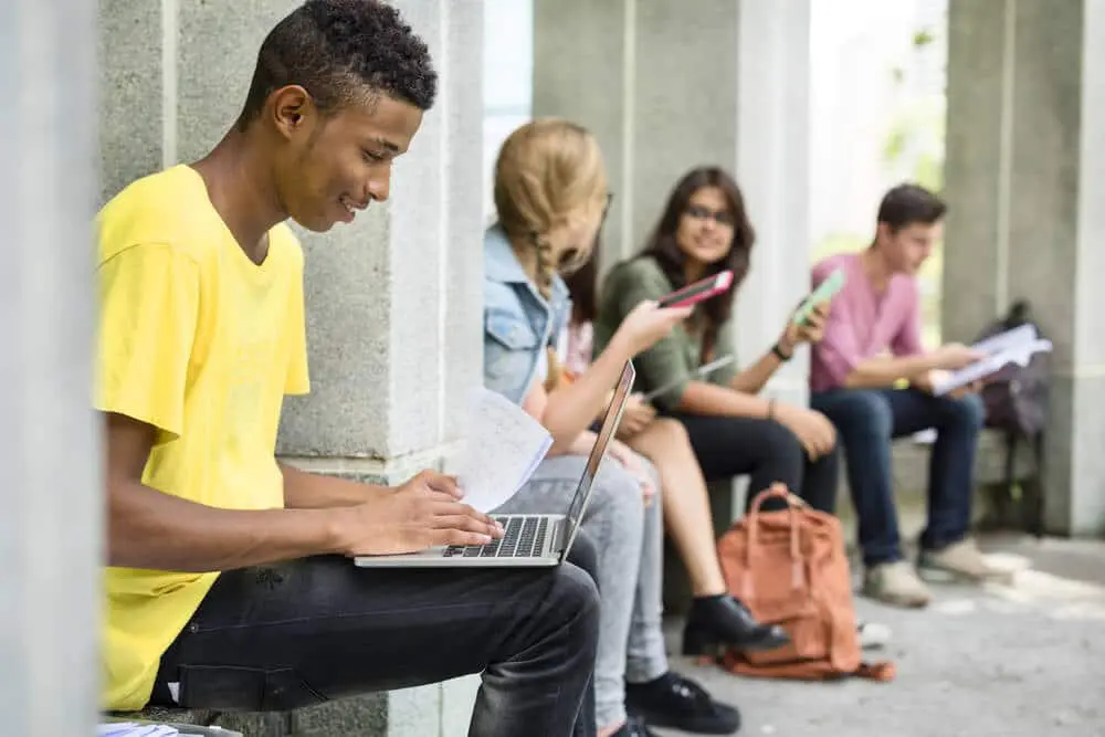 Prepare For Your College Campus Tour Young Man Working on his Laptop | Gurnick Academy of Medical Arts