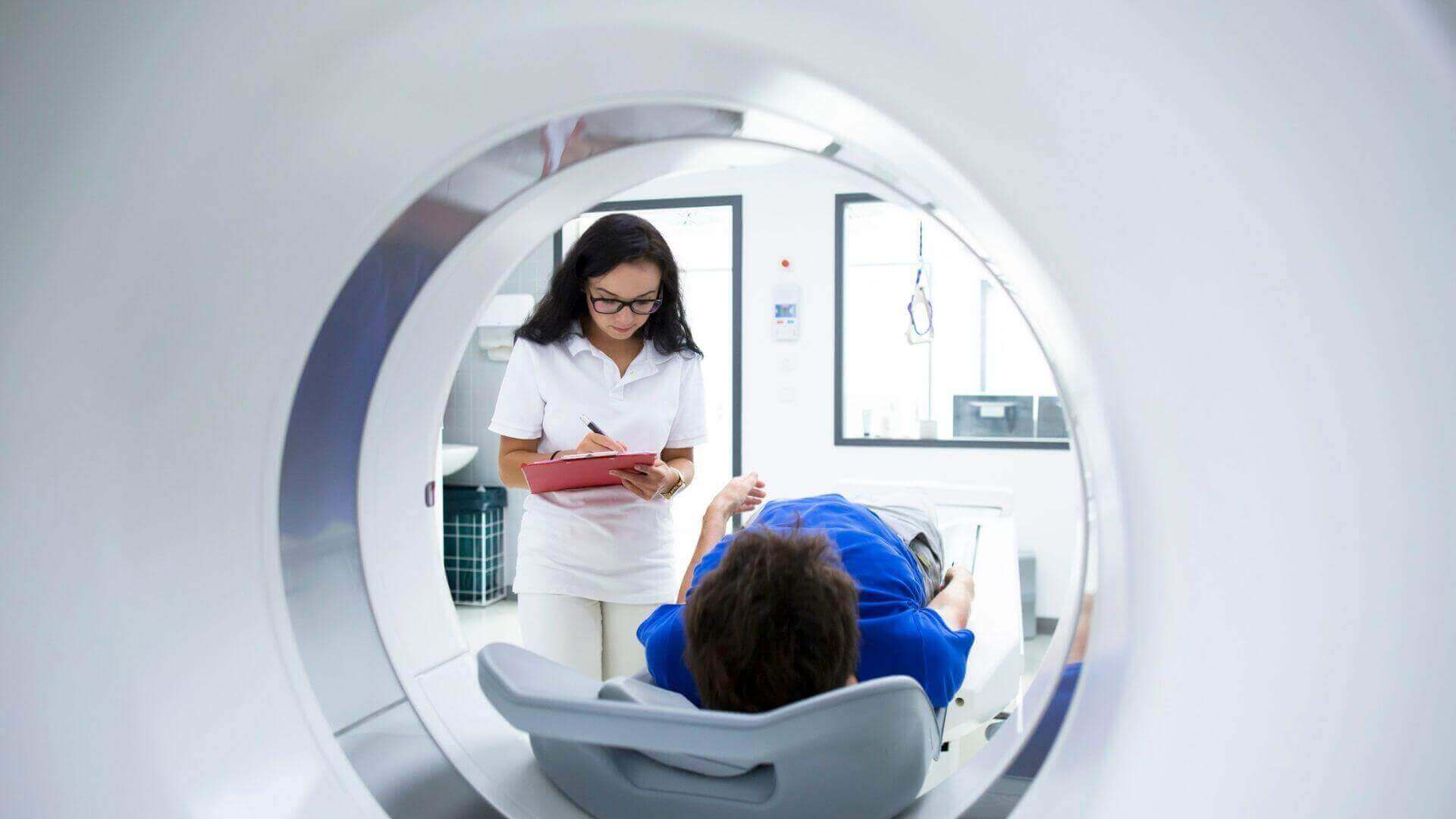 nuclear medicine technologist scanning patient