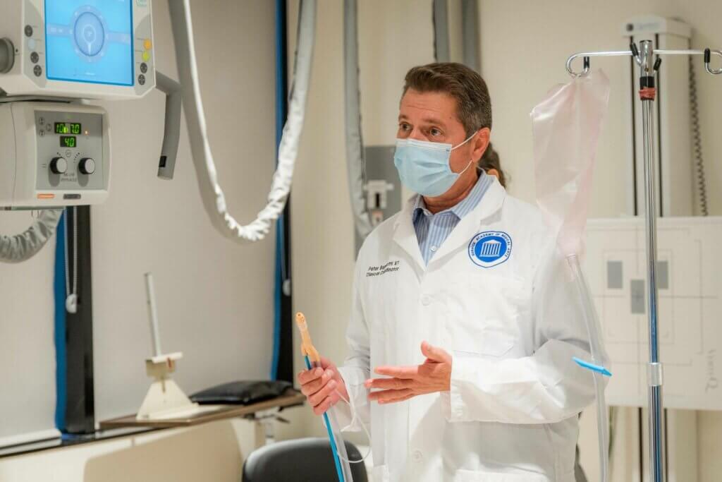 Man wearing a whitecoat in a Gurnick Academy lab.